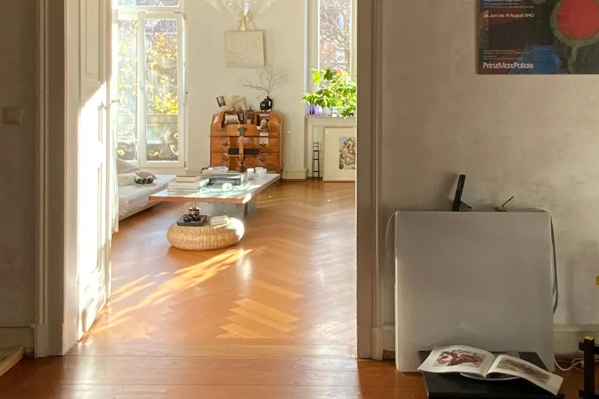 Ljust bostadsrum med möbler samlade och dagsljus från stora fönster